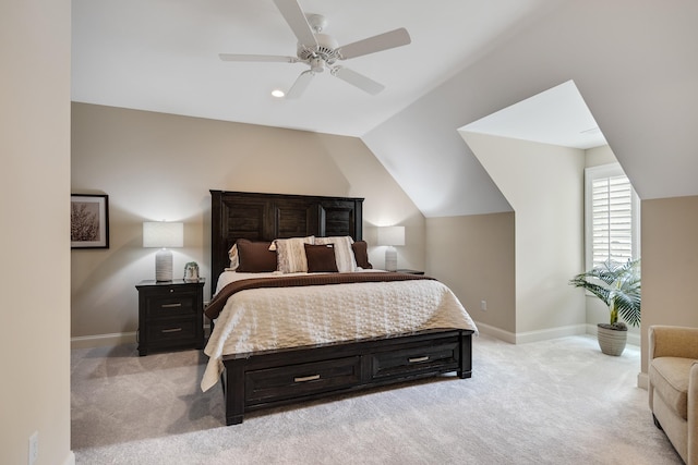 bedroom with baseboards, ceiling fan, light colored carpet, and vaulted ceiling