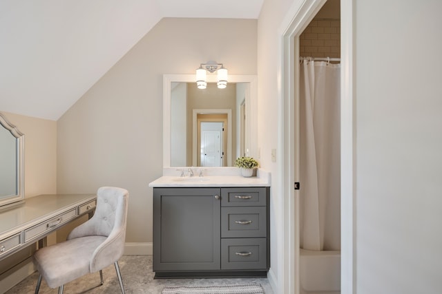 bathroom with baseboards, curtained shower, lofted ceiling, and vanity