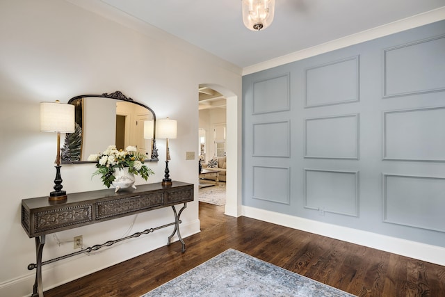entryway with baseboards, dark wood finished floors, and arched walkways