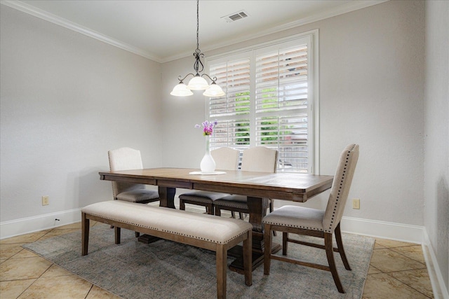 dining area with baseboards, visible vents, light tile patterned floors, and crown molding