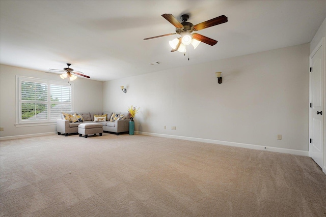 carpeted living area featuring ceiling fan and baseboards