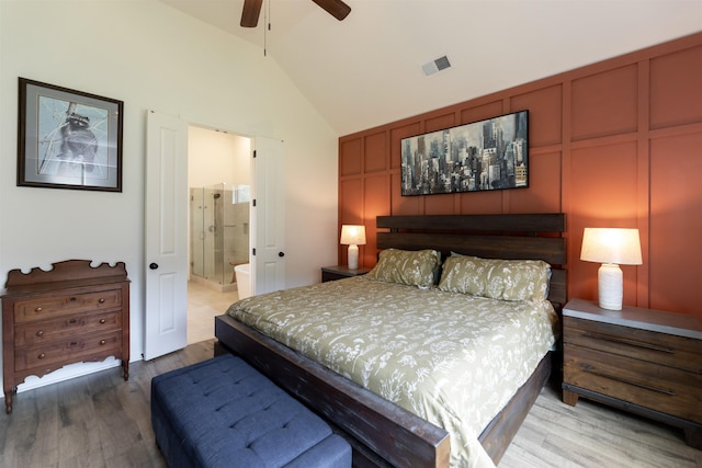 bedroom with wood finished floors, connected bathroom, vaulted ceiling, ceiling fan, and visible vents