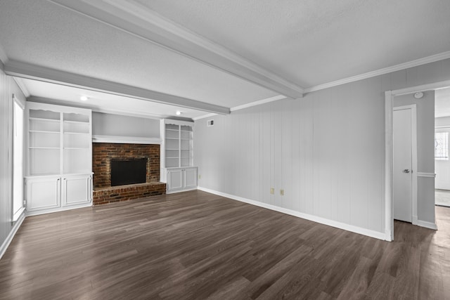 unfurnished living room with a textured ceiling, crown molding, beamed ceiling, and dark wood finished floors