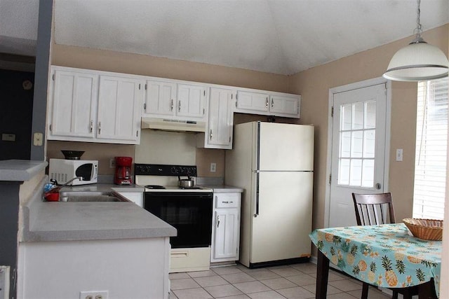 kitchen with a healthy amount of sunlight, white appliances, under cabinet range hood, and light countertops