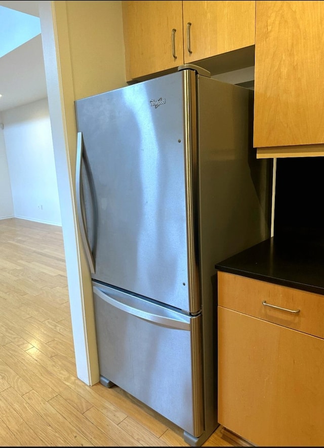 415 S Front St Unit 120, Memphis, TN 38103 - kitchen featuring light wood finished floors, dark countertops, and freestanding refrigerator