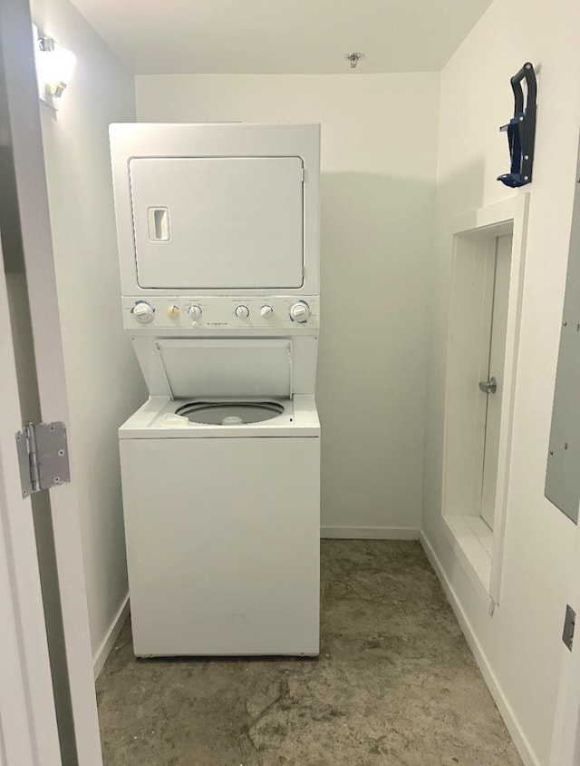 415 S Front St Unit 120, Memphis, TN 38103 - clothes washing area with baseboards, stacked washer and dryer, and laundry area