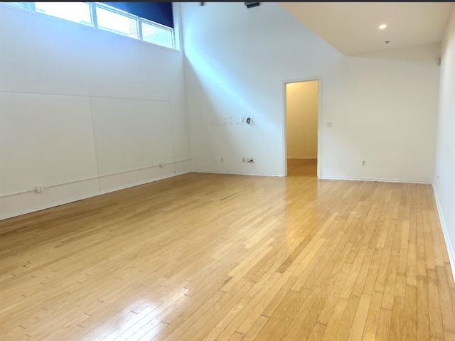 415 S Front St Unit 120, Memphis, TN 38103 - empty room with a towering ceiling, light wood-type flooring, and baseboards