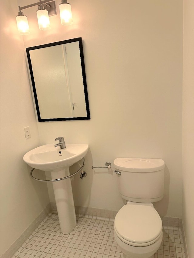 415 S Front St Unit 120, Memphis, TN 38103 - half bath with baseboards, tile patterned floors, toilet, and a sink