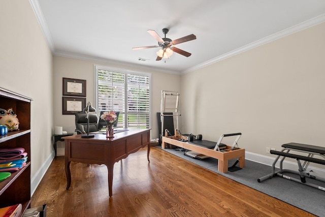 home office featuring ornamental molding, wood finished floors, and baseboards
