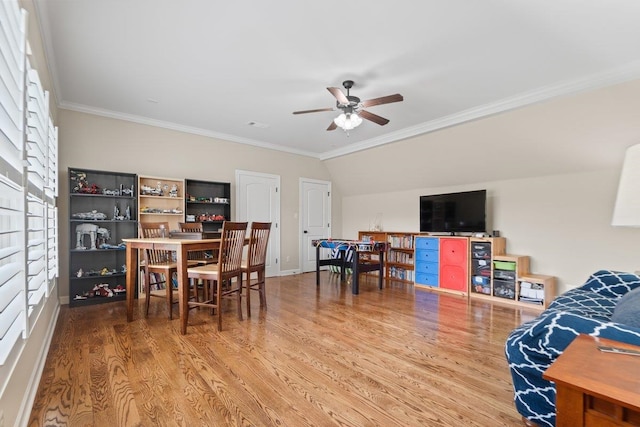 dining space with crown molding, a ceiling fan, visible vents, baseboards, and wood finished floors