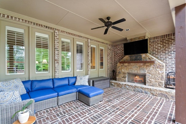 view of patio / terrace with an outdoor living space with a fireplace and ceiling fan