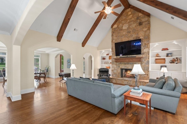 living room featuring a fireplace, high vaulted ceiling, a ceiling fan, baseboards, and wood finished floors