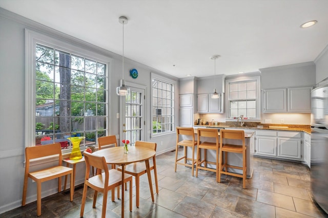 interior space featuring ornamental molding and a healthy amount of sunlight
