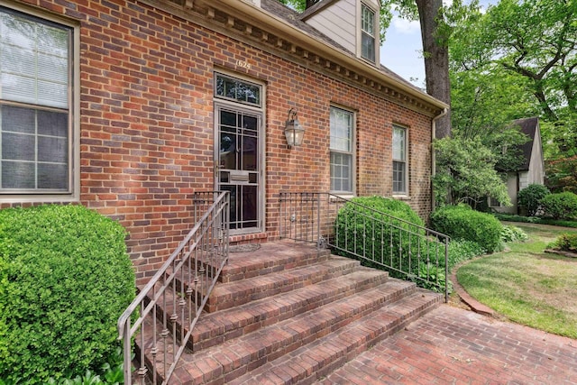 doorway to property with brick siding