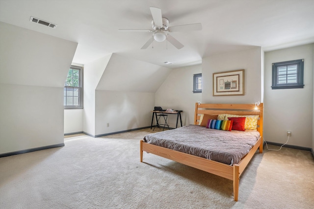 carpeted bedroom with visible vents, baseboards, and multiple windows