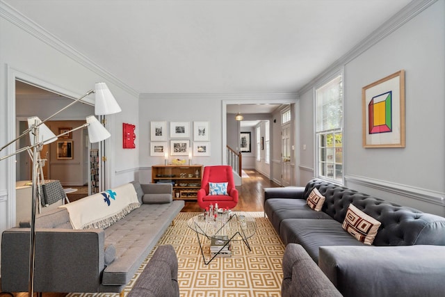 living room with crown molding, stairway, and wood finished floors