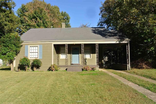 bungalow-style house featuring covered porch and a front lawn