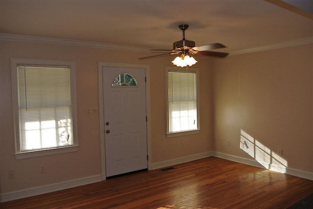 foyer featuring wood finished floors, visible vents, ornamental molding, and baseboards