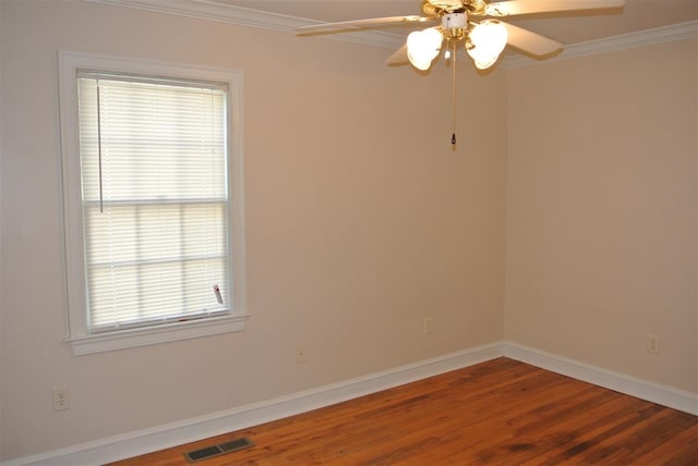 unfurnished room with crown molding, visible vents, ceiling fan, and wood finished floors