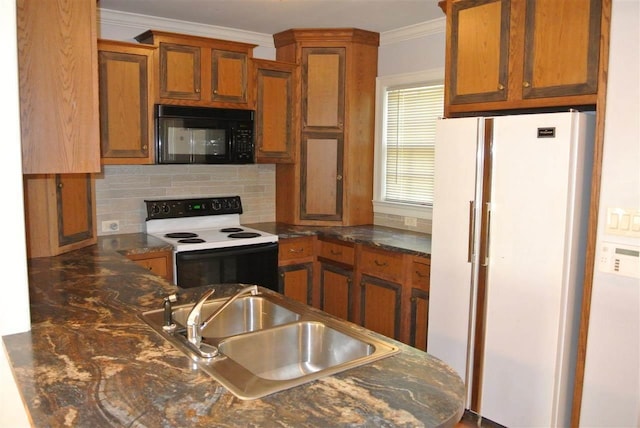 kitchen featuring electric range oven, black microwave, ornamental molding, dark countertops, and freestanding refrigerator