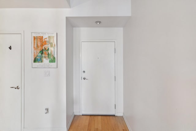 interior space with baseboards and light wood-style flooring
