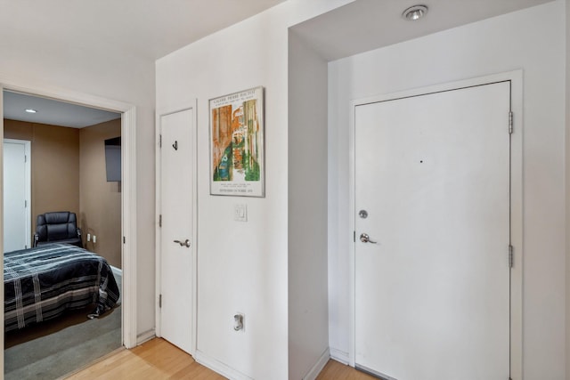 entryway featuring baseboards and light wood-style flooring