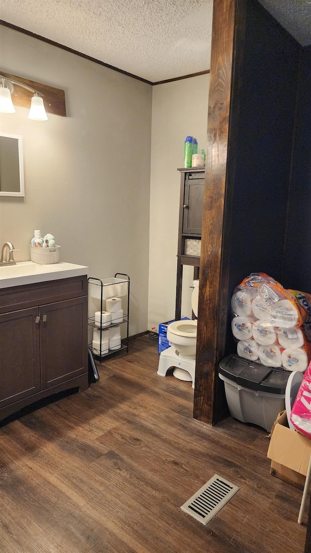56 Central Curve Rd, Ripley, TN 38063 - bathroom featuring wood finished floors, toilet, visible vents, and vanity