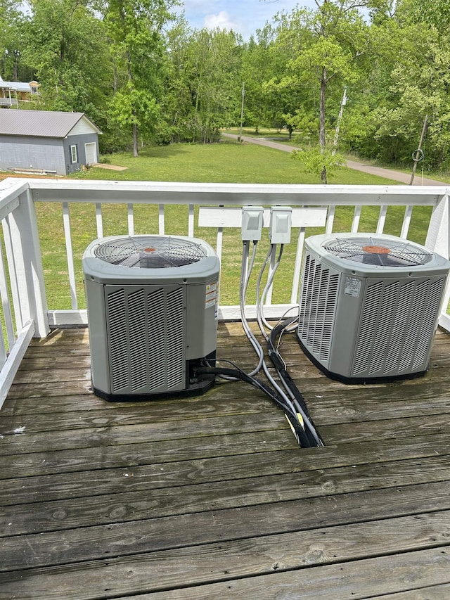 deck with central AC unit and a yard