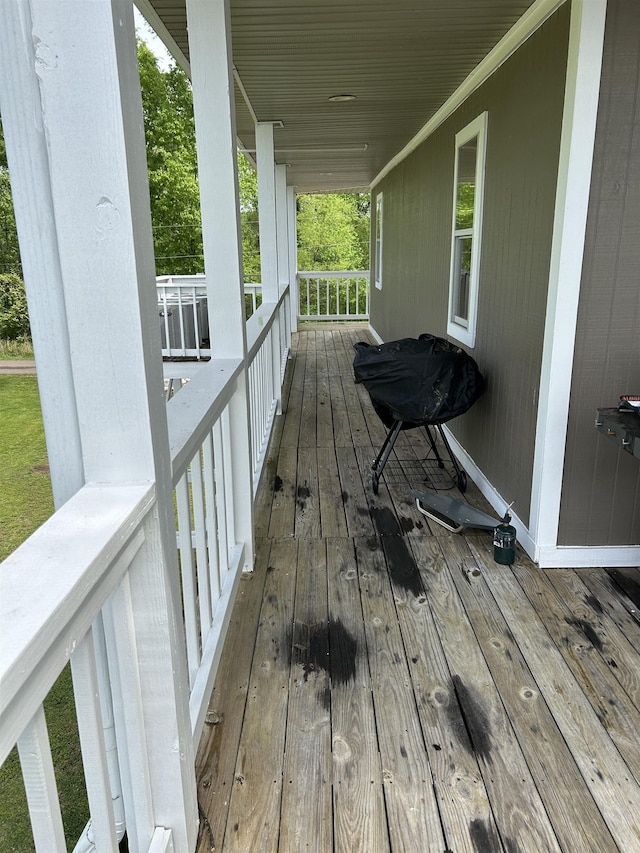 deck featuring covered porch and a grill