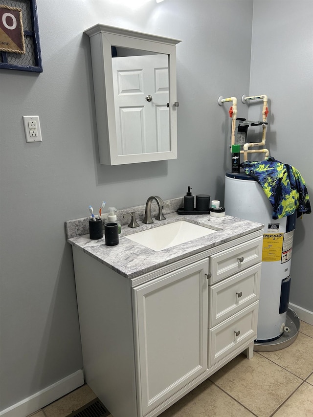 bathroom with tile patterned flooring, vanity, and baseboards