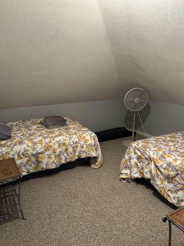 bedroom featuring carpet floors, a textured ceiling, and vaulted ceiling