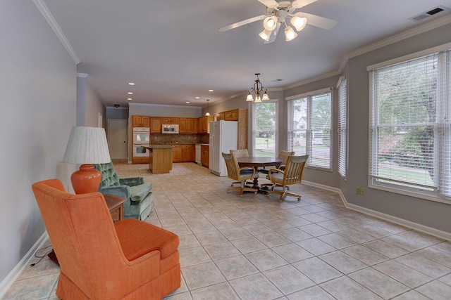 living area with light tile patterned floors, visible vents, ornamental molding, and baseboards