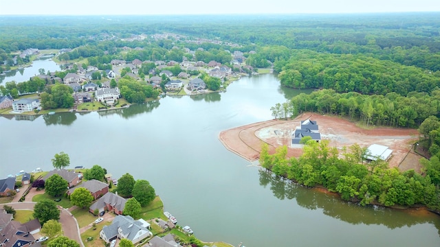 bird's eye view featuring a forest view, a residential view, and a water view