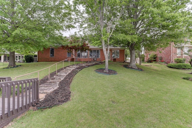 exterior space with a front lawn and brick siding