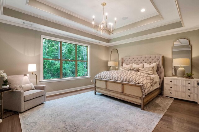 515 Saunders Creek Cir, Rossville, TN 38066 - bedroom featuring wood finished floors, a chandelier, a tray ceiling, and ornamental molding