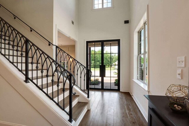 515 Saunders Creek Cir, Rossville, TN 38066 - entrance foyer with dark wood finished floors, visible vents, baseboards, stairway, and a high ceiling