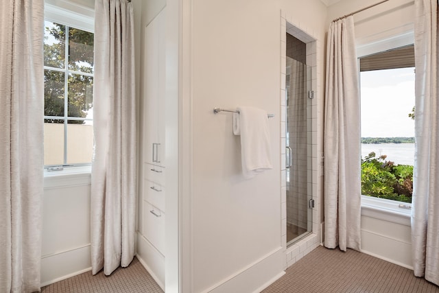 full bathroom featuring a stall shower and tile patterned flooring