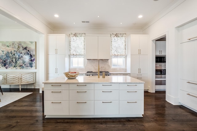 kitchen with visible vents, light stone countertops, ornamental molding, and oven