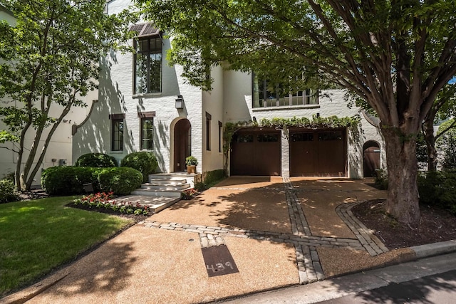 view of front of home featuring concrete driveway and a garage