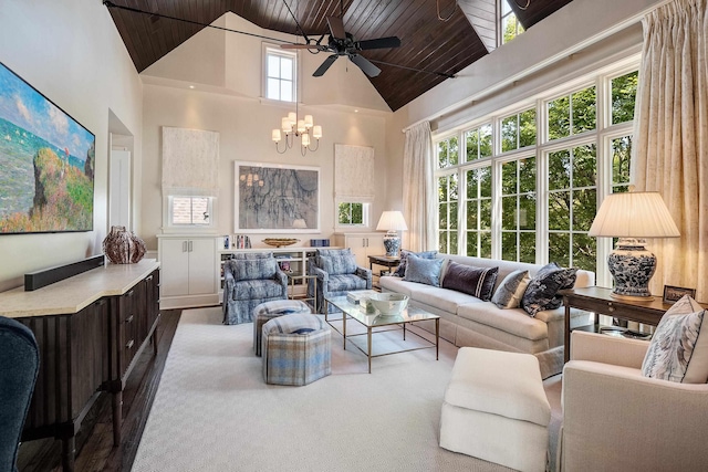 living area featuring wooden ceiling, high vaulted ceiling, and ceiling fan with notable chandelier