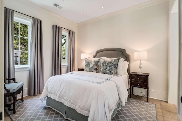 bedroom featuring ornamental molding, visible vents, and baseboards