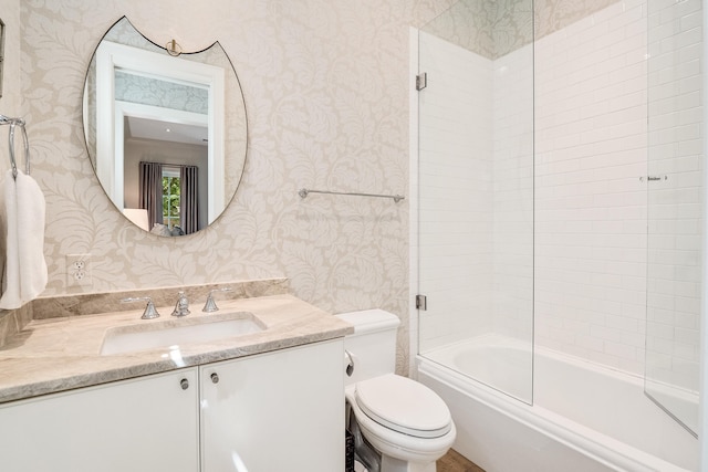 full bathroom featuring toilet, wallpapered walls, enclosed tub / shower combo, and vanity