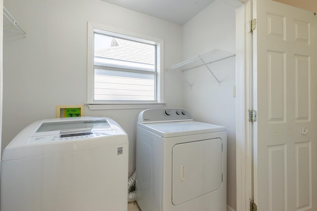 clothes washing area with washing machine and clothes dryer and laundry area