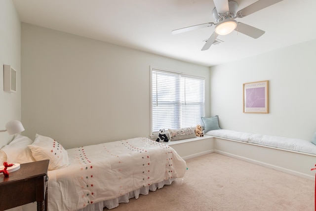 carpeted bedroom with a ceiling fan and baseboards