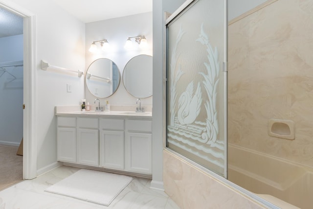 full bathroom with marble finish floor, double vanity, and a sink