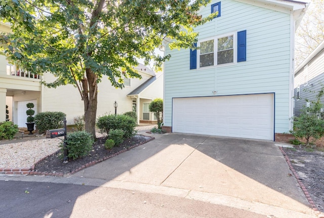 view of front of property with concrete driveway and a garage