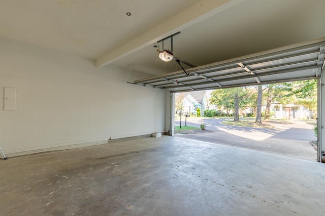 garage featuring electric panel and a garage door opener