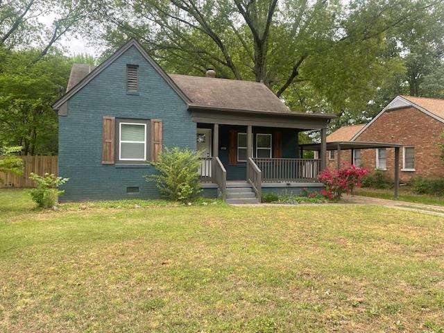 bungalow-style home featuring a porch, a front yard, crawl space, and fence