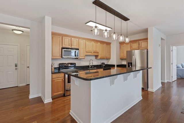 730 Litty Ct Unit 204, Memphis, TN 38103 - kitchen with hanging light fixtures, appliances with stainless steel finishes, dark wood-style flooring, a kitchen bar, and a center island