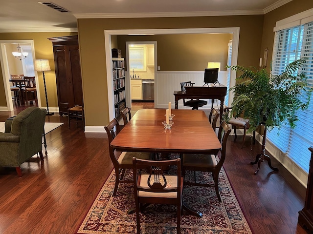 dining room featuring visible vents, ornamental molding, and dark wood-type flooring